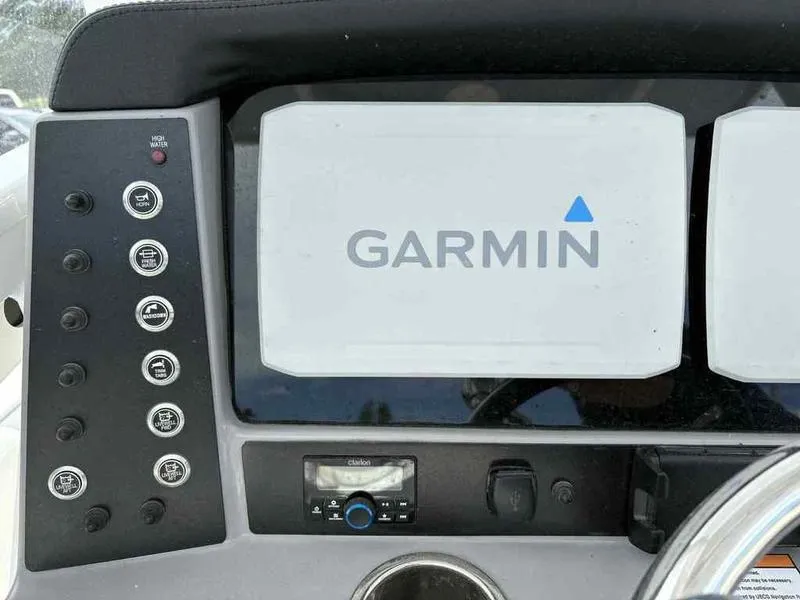 Slide: The Image of 2024 Robalo 246 Cayman dashboard featuring Garmin navigation system and control panel. - 15