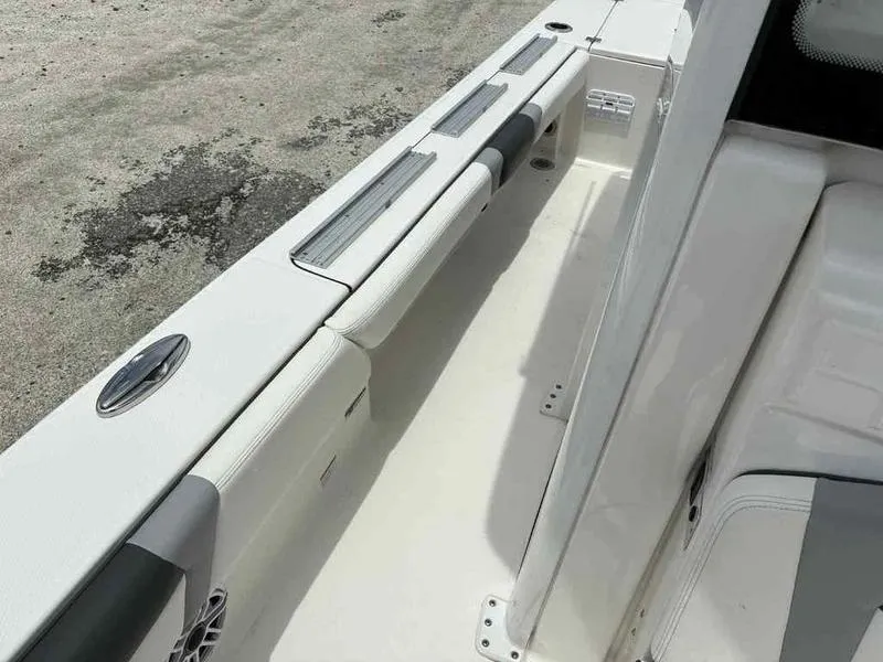 Slide: The Image of 2024 Robalo 246 Cayman boat interior, featuring sleek seating and storage compartments. - 17