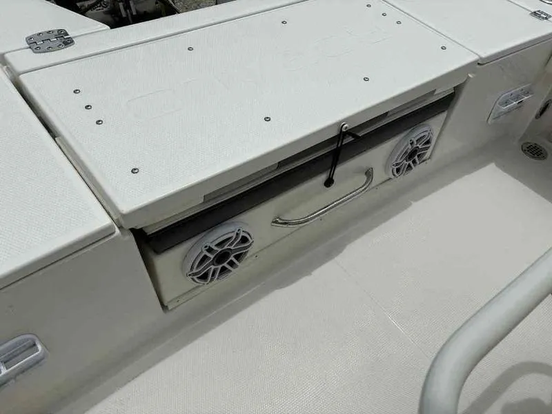 Slide: The Image of 2024 Robalo 246 Cayman boat interior with storage compartment and speakers. - 19