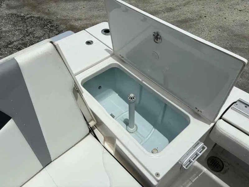 Slide: The Image of 2024 Robalo 246 Cayman boat livewell with open lid, showcasing interior design. - 21