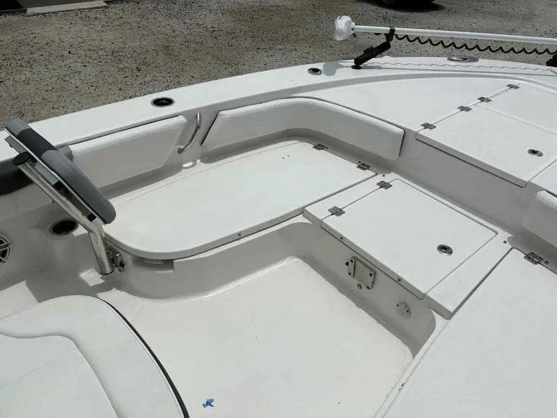 Slide: The Image of 2024 Robalo 246 Cayman boat interior with seating and storage compartments. - 22