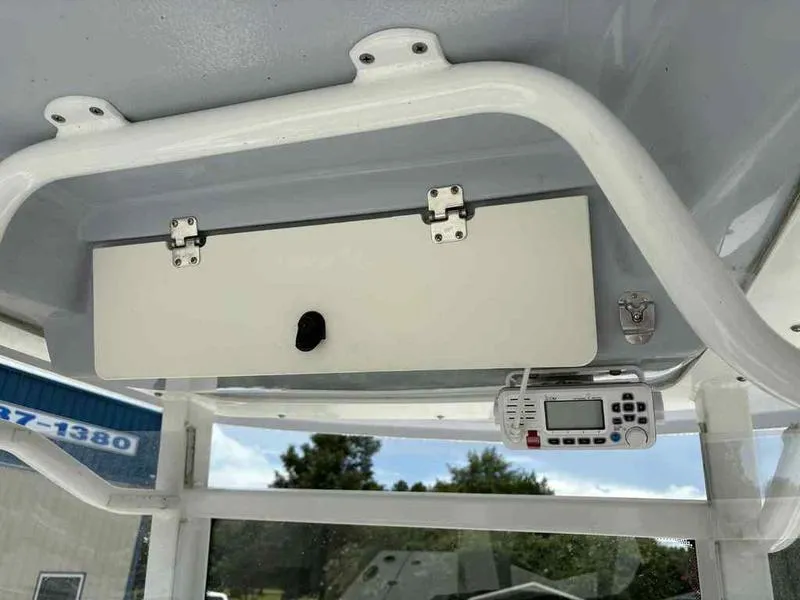 Slide: The Image of 2024 Robalo 246 Cayman boat console with storage compartment and electronic device. - 25