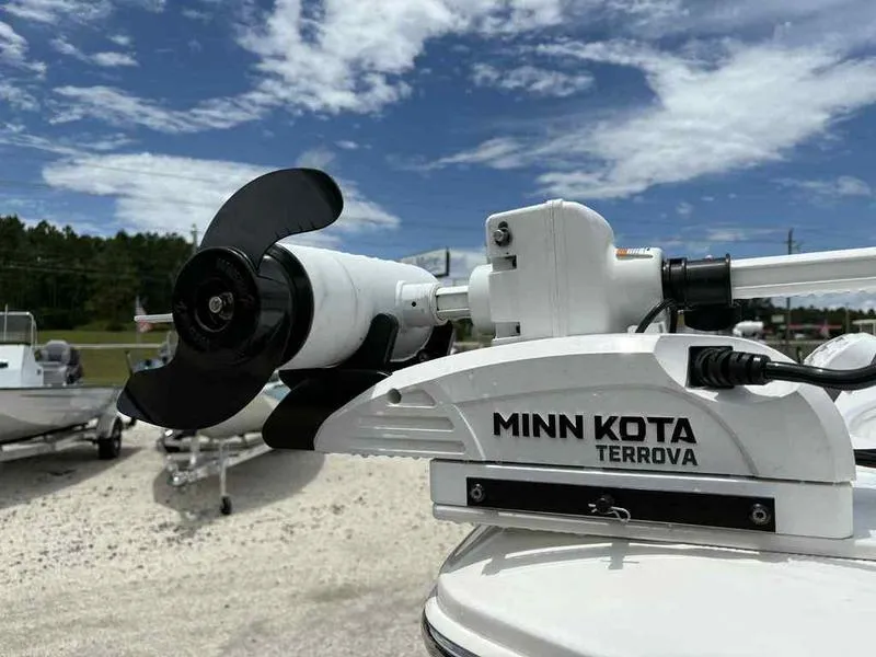 Slide: The Image of Minn Kota Terrova motor on 2024 Robalo 246 Cayman boat under a clear blue sky. - 26