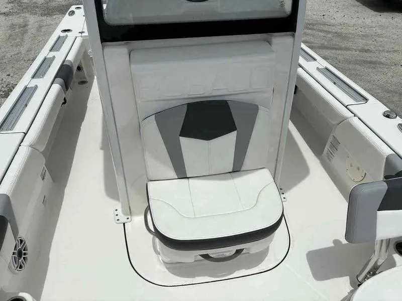 Slide: The Image of 2024 Robalo 246 Cayman boat interior with cushioned seating and sleek design. - 28
