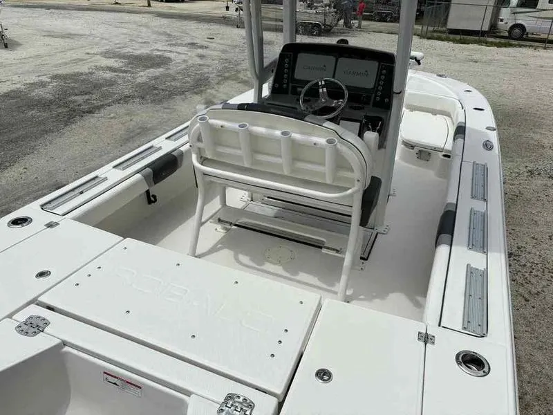 Slide: The Image of 2024 Robalo 246 Cayman boat interior with helm, seating, and storage compartments. - 7