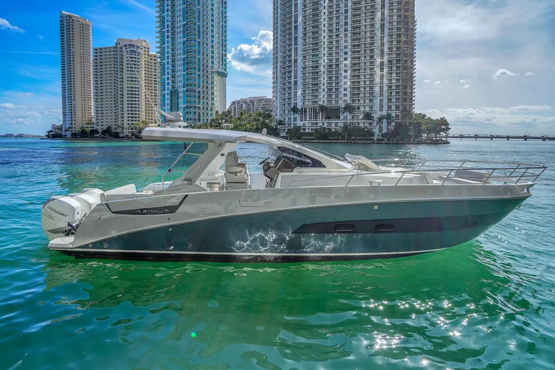 The Image of 2020 Azimut Verve 40 yacht cruising near city skyline on clear water. - 0
