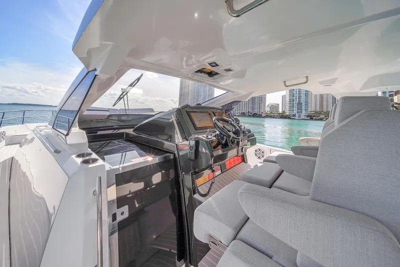 Slide: The Image of Azimut Verve 40 yacht cockpit, 2020 model, with modern controls and waterfront city view. - 18
