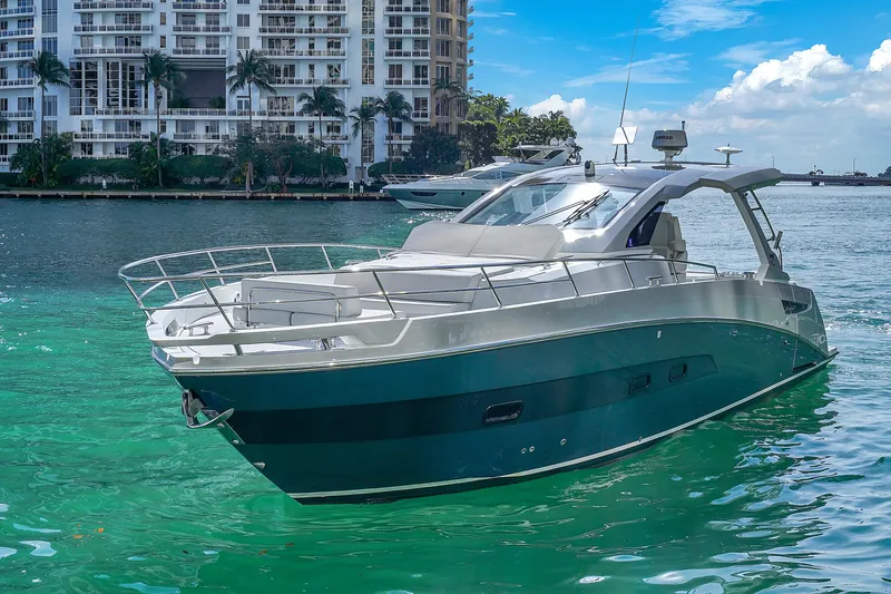 Slide: The Image of 2020 Azimut Verve 40 yacht on turquoise water near urban skyline. - 2