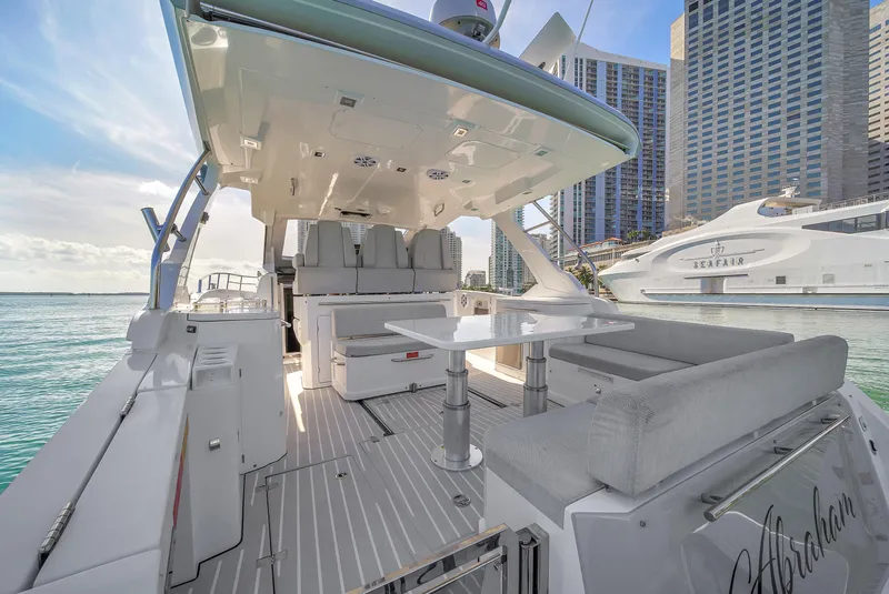 Slide: The Image of 2020 Azimut Verve 40 yacht with sleek deck and modern seating, docked in a marina. - 7