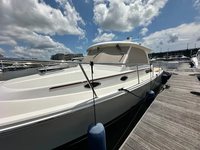 Slide: The Image of 2022 Back Cove 34O boat docked under a partly cloudy sky. - 11