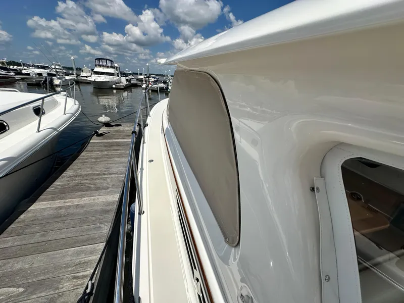 Slide: The Image of 2022 Back Cove 34O yacht docked at marina under blue sky. - 14