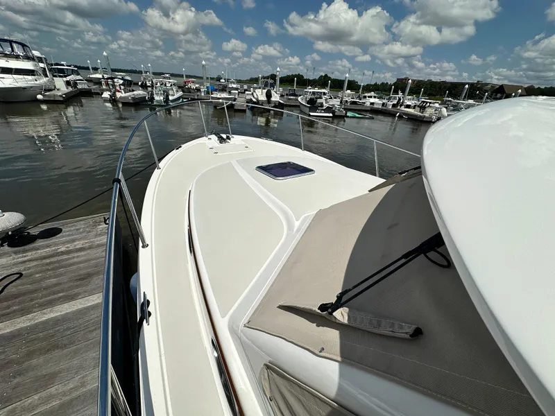 Slide: The Image of 2022 Back Cove 34O yacht docked at marina under a partly cloudy sky. - 16