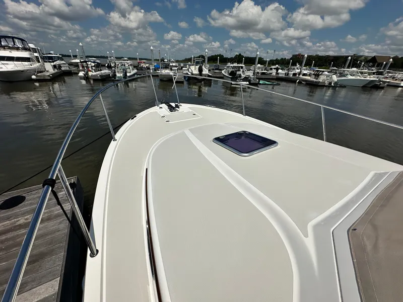 Slide: The Image of 2022 Back Cove 34O yacht docked at marina under blue sky. - 17