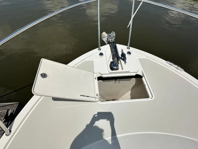 Slide: The Image of Bow of 2022 Back Cove 34O boat with open anchor locker and water view. - 20