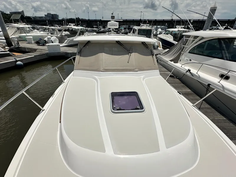 Slide: The Image of 2022 Back Cove 34O yacht docked at marina, showcasing sleek design and spacious deck. - 21