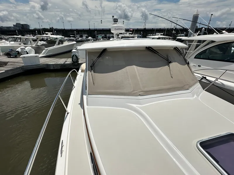 Slide: The Image of 2022 Back Cove 34O yacht docked at marina under cloudy sky. - 22