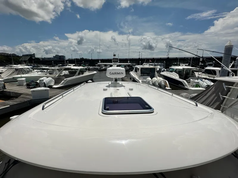 Slide: The Image of 2022 Back Cove 34O yacht docked at marina under cloudy sky. - 23