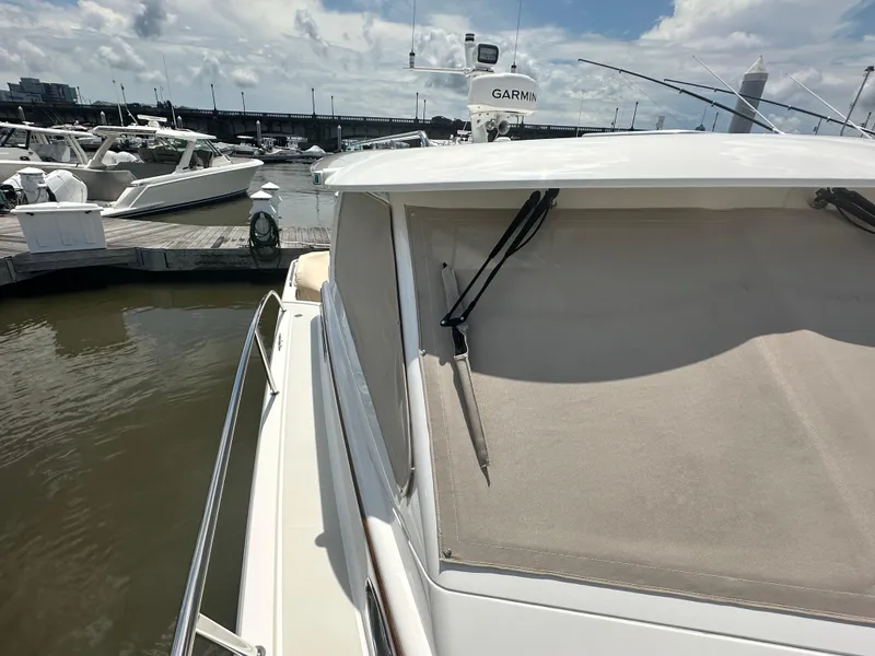 Slide: The Image of 2022 Back Cove 34O yacht docked at marina under cloudy sky. - 24