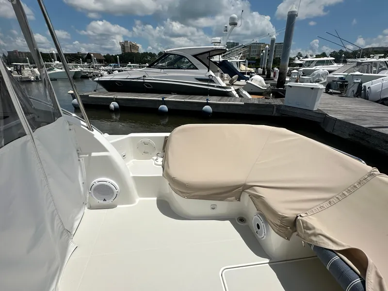 Slide: The Image of 2022 Back Cove 34O boat docked at marina under a partly cloudy sky. - 26