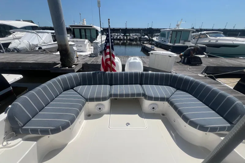 Slide: The Image of 2022 Back Cove 34O boat with striped seating at a marina dock. - 27