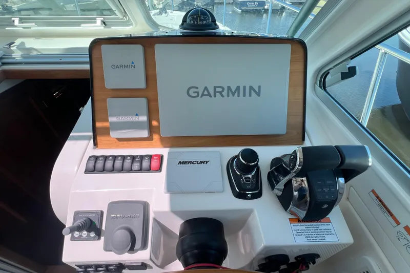 Slide: The Image of 2022 Back Cove 34O helm with Garmin navigation and Mercury controls. - 29