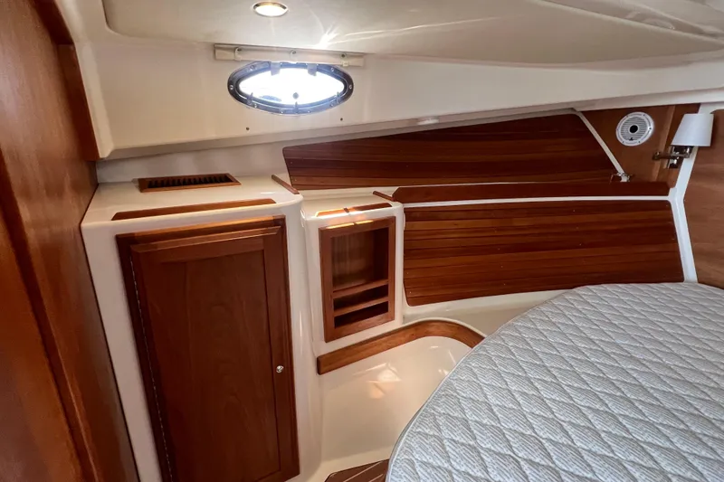 Slide: The Image of Interior of 2022 Back Cove 34O boat with wood paneling and porthole window. - 34