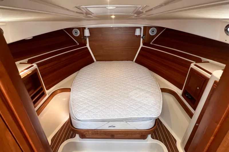 Slide: The Image of Luxurious cabin interior of 2022 Back Cove 34O yacht with cozy bed and wooden accents. - 35