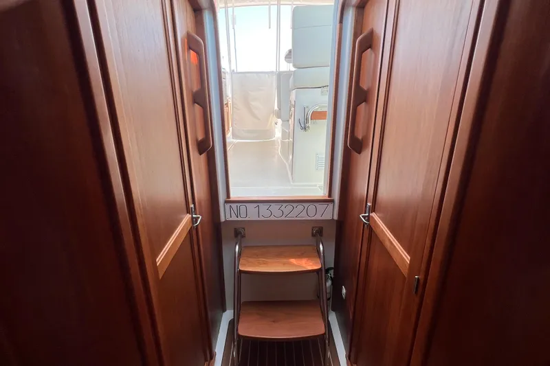Slide: The Image of Interior view of 2022 Back Cove 34O yacht with wooden cabinetry and steps. - 39