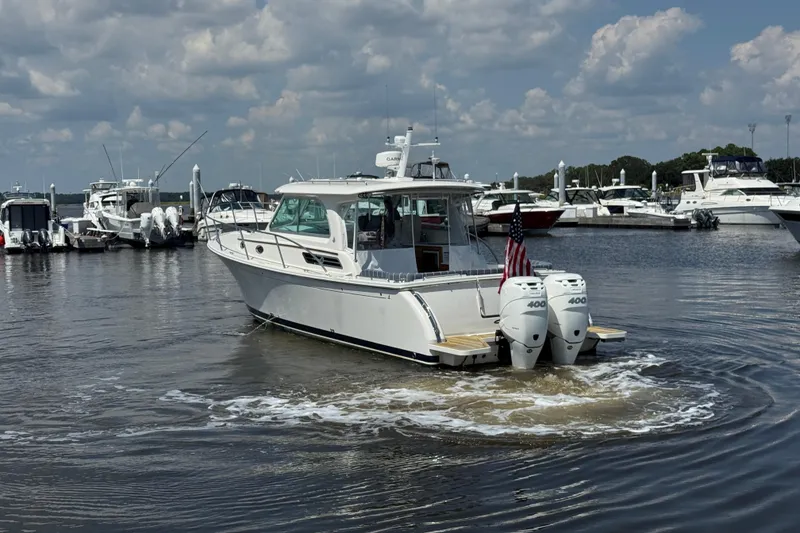 Slide: The Image of 2022 Back Cove 34O boat with twin engines in a marina setting. - 4