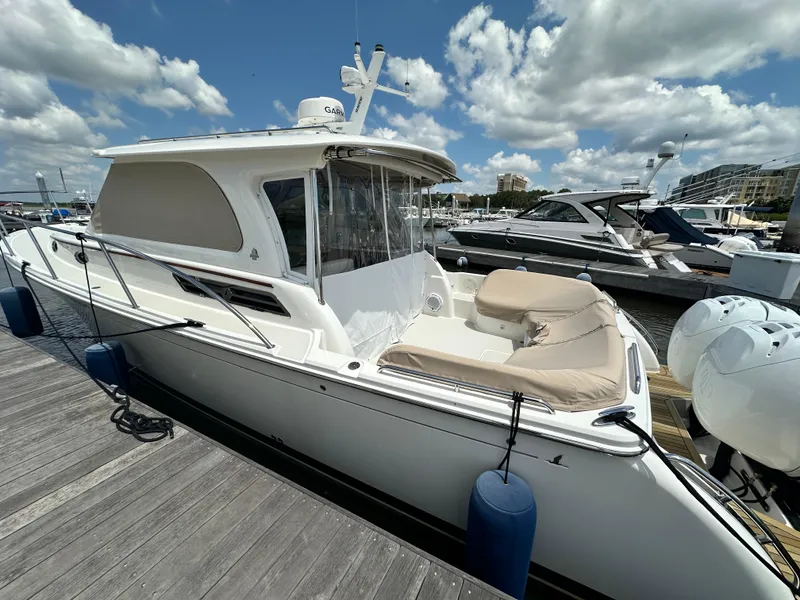 Slide: The Image of 2022 Back Cove 34O boat docked at marina under a partly cloudy sky. - 41