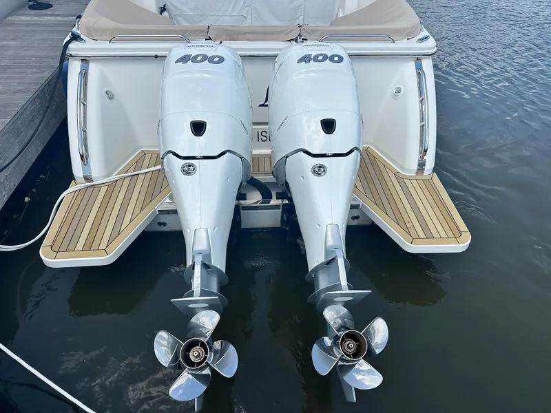 Slide: The Image of 2022 Back Cove 34O boat with twin 400 horsepower outboard engines, docked on water. - 44