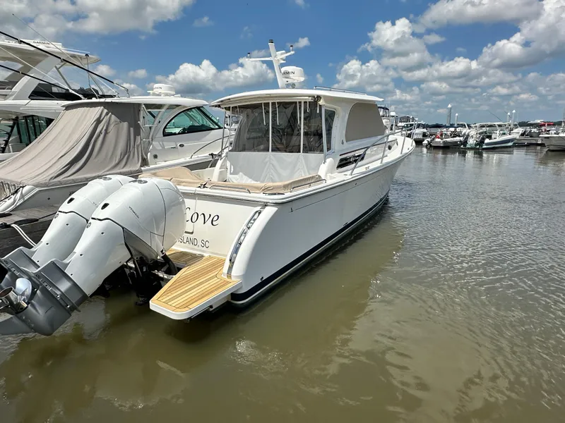 Slide: The Image of 2022 Back Cove 34O boat docked in marina under blue sky. - 46