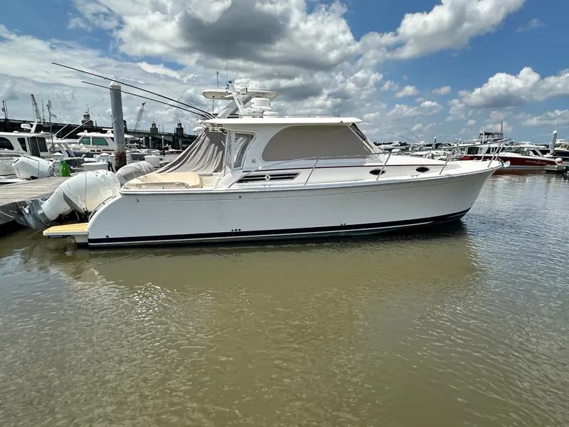 Slide: The Image of 2022 Back Cove 34O boat docked in marina under partly cloudy sky. - 47