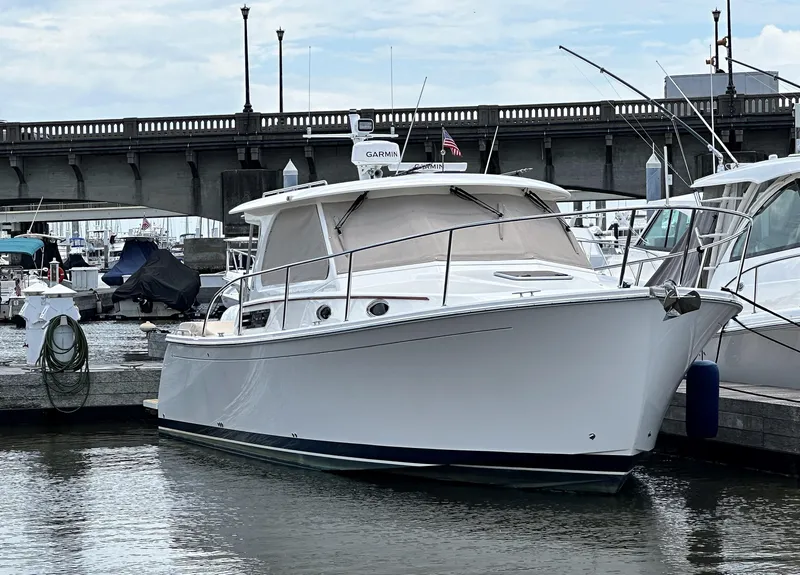 Slide: The Image of 2022 Back Cove 34O yacht docked near a bridge in a marina. - 48