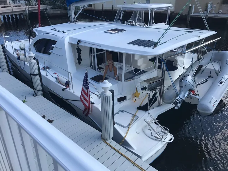 Slide: The Image of 2013 Leopard 44 catamaran docked with American flag and inflatable dinghy. - 10