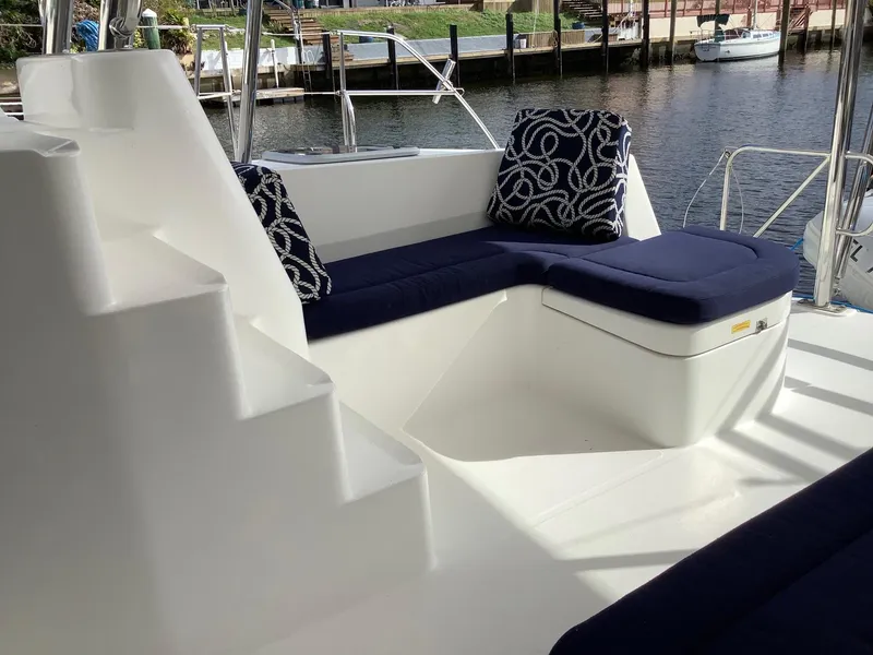 Slide: The Image of 2013 Leopard 44 yacht deck with blue cushioned seating and nautical-themed pillows. - 13