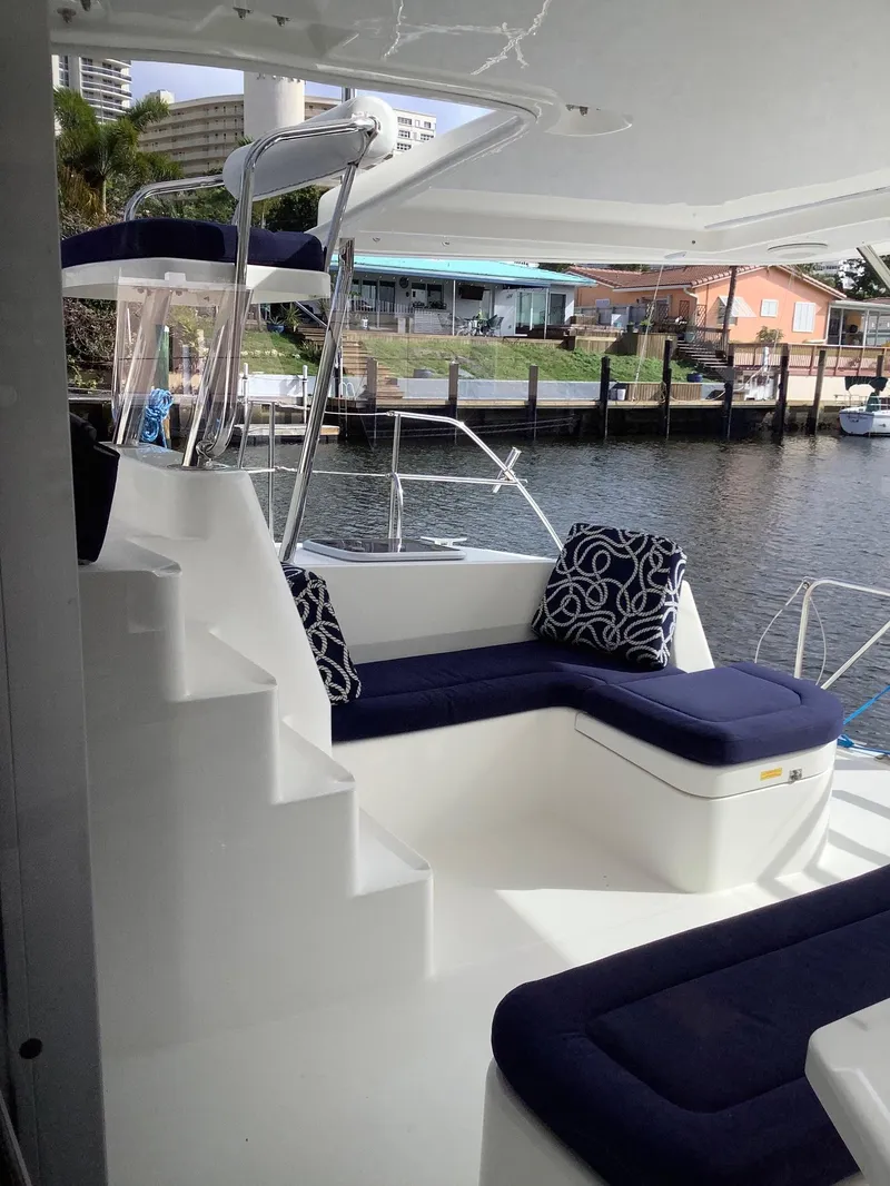 Slide: The Image of Luxurious 2013 Leopard 44 yacht with elegant seating and waterfront view. - 14