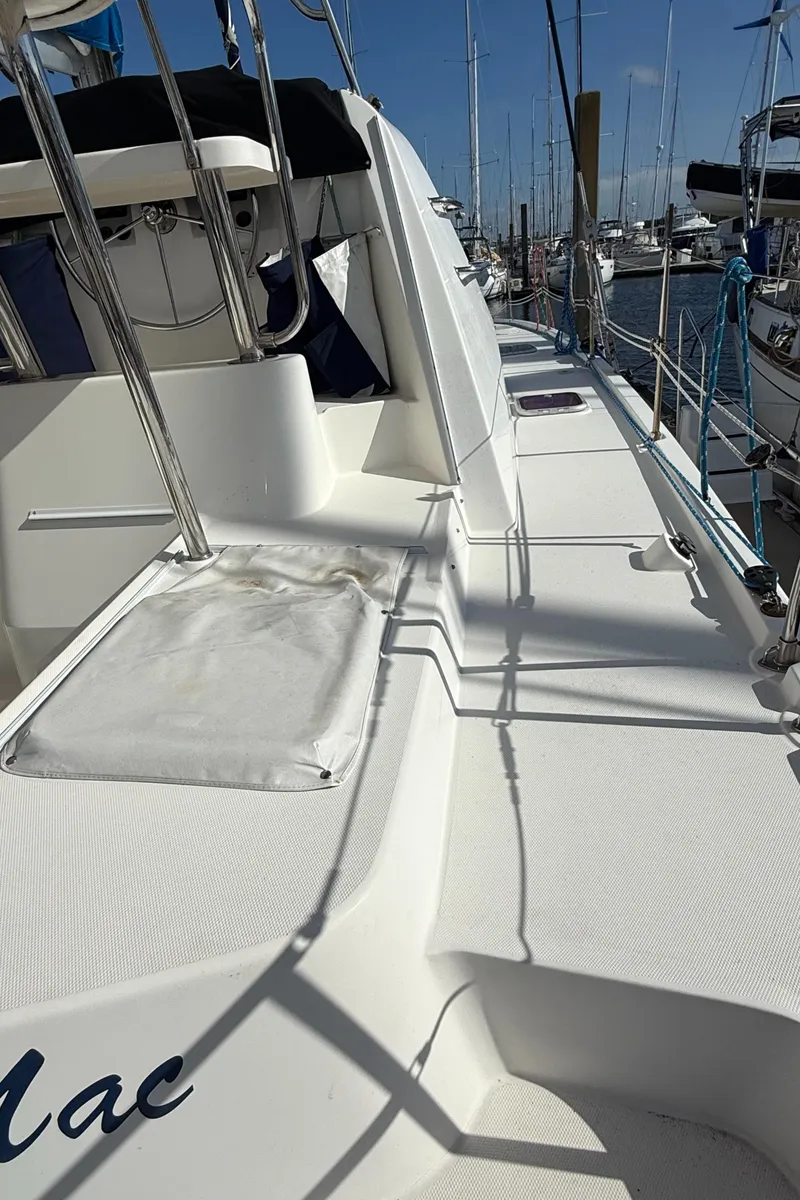 Slide: The Image of Deck view of a 2013 Leopard 44 catamaran in a marina setting. - 16