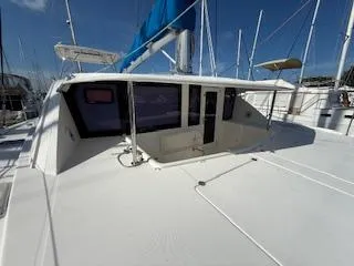 Slide: The Image of 2013 Leopard 44 catamaran with blue sail, docked in marina under clear sky. - 17