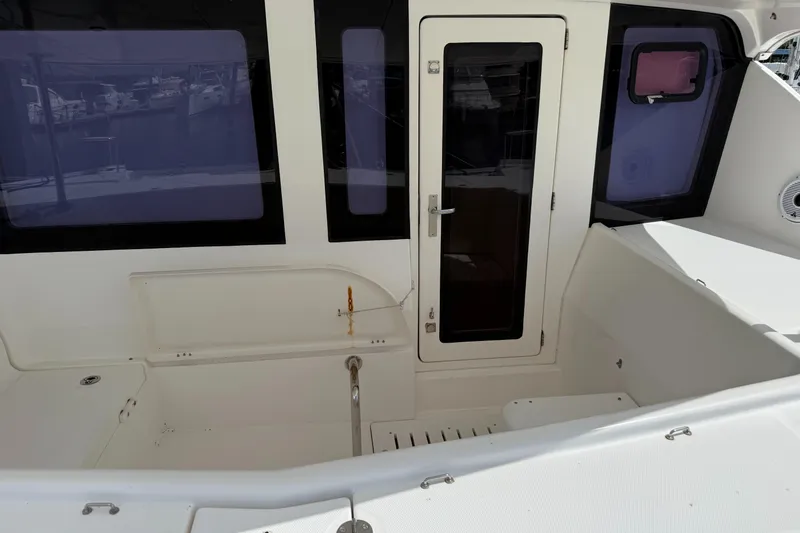 Slide: The Image of Leopard 44 yacht cockpit with white seating and glass door, 2013 model. - 21