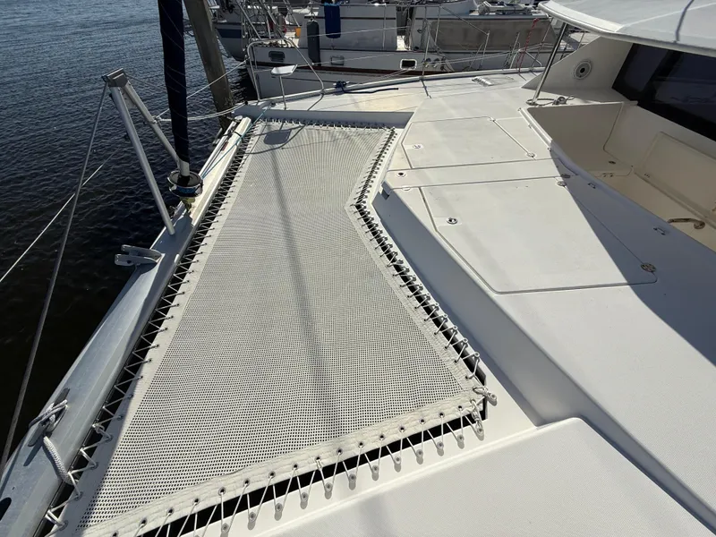 Slide: The Image of Deck view of a 2013 Leopard 44 catamaran with netting and hatches. - 24