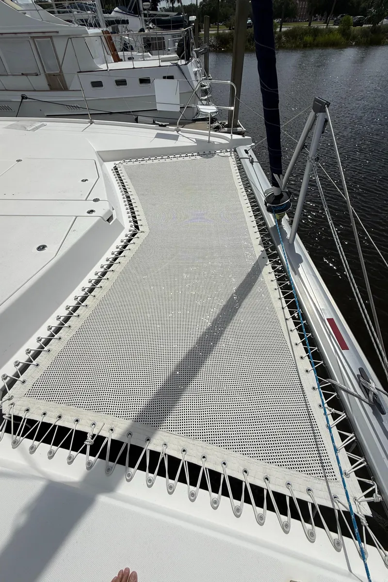 Slide: The Image of Leopard 44 catamaran deck with netting, docked by the water, 2013 model. - 25