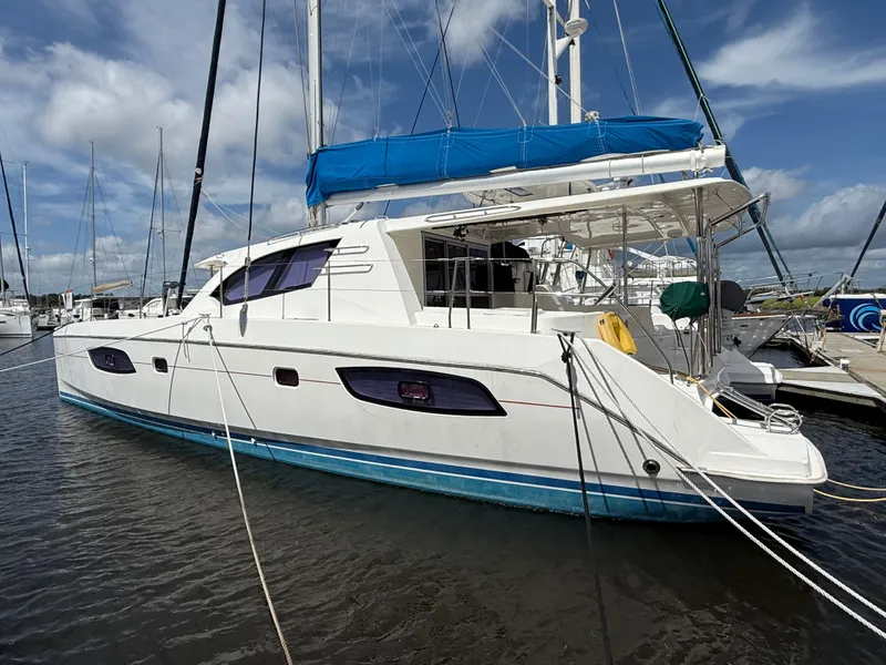 Slide: The Image of 2013 Leopard 44 catamaran docked at marina under blue sky. - 3
