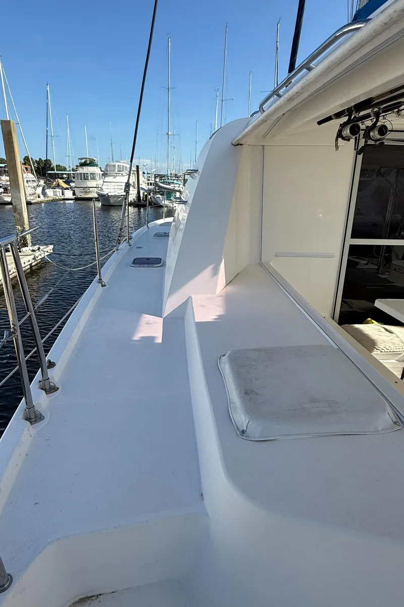 Slide: The Image of 2013 Leopard 44 catamaran deck view in marina, showcasing sleek design and spacious layout. - 30