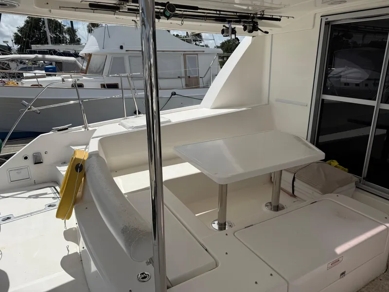 Slide: The Image of Leopard 44 yacht deck with seating and table, docked at marina, 2013 model. - 38