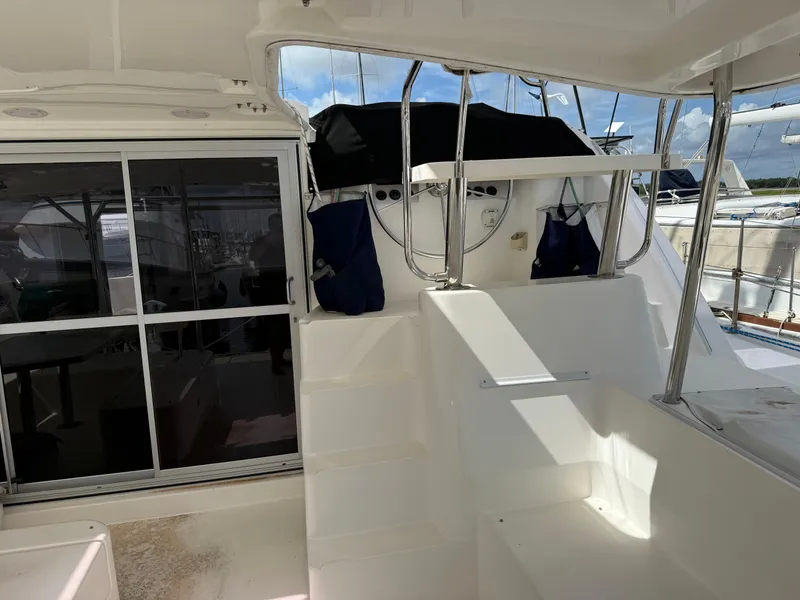 Slide: The Image of Interior view of a 2013 Leopard 44 catamaran, featuring stairs and a sliding glass door. - 41