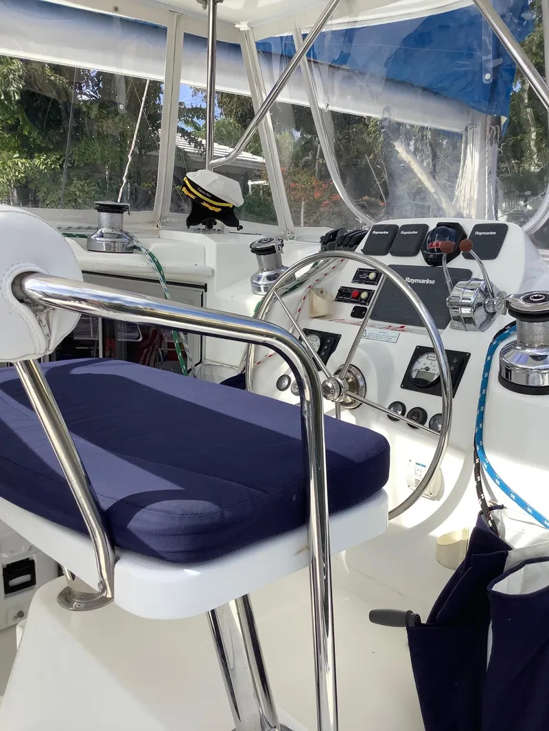 Slide: The Image of Helm station of 2013 Leopard 44 catamaran with steering wheel and navigation controls. - 42