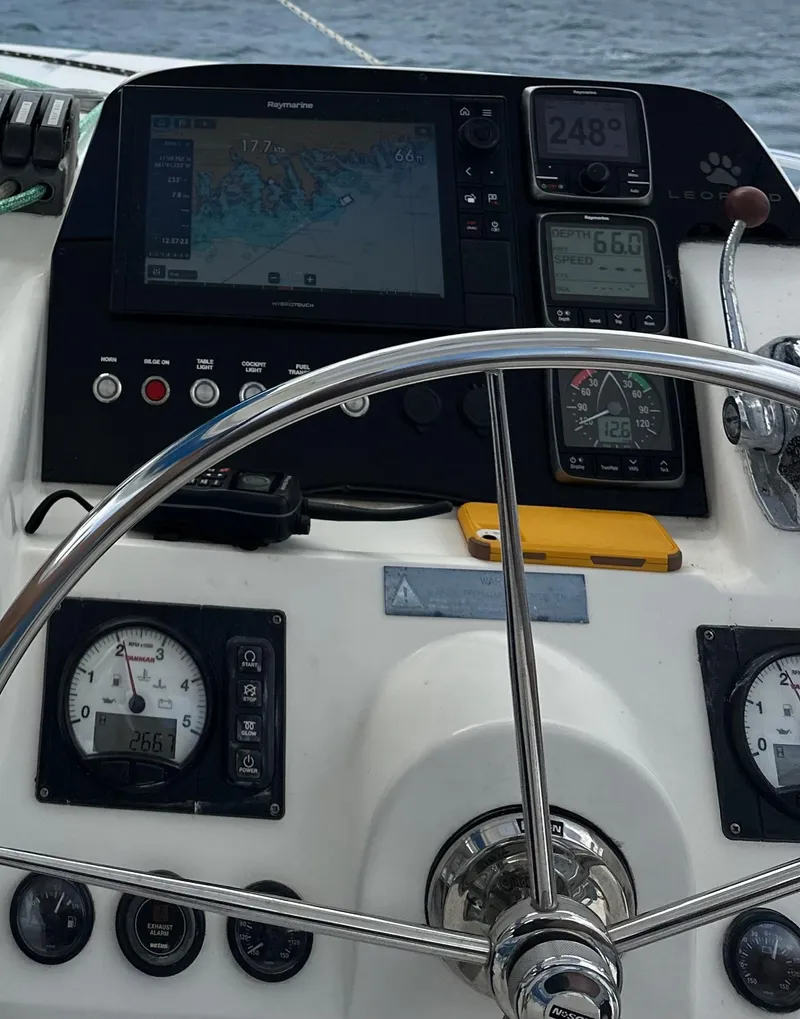Slide: The Image of Steering wheel and navigation instruments on a 2013 Leopard 44 catamaran. - 46