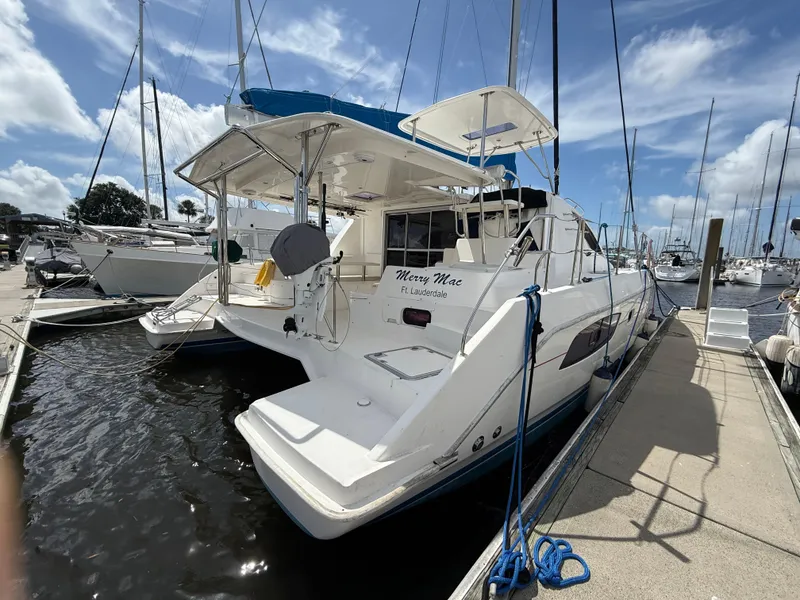 Slide: The Image of 2013 Leopard 44 catamaran docked at marina, sunny day, blue sky, "Merry Mac" on stern. - 5