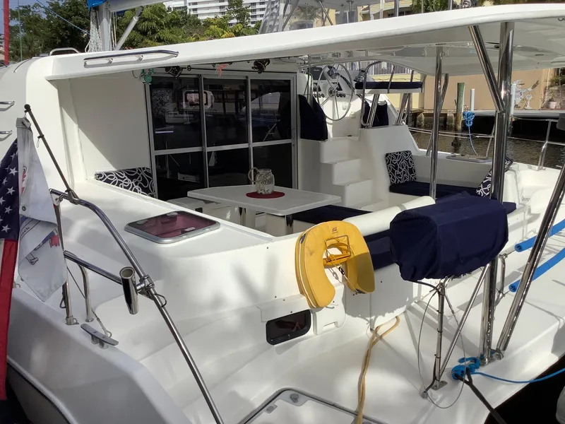 Slide: The Image of Leopard 44 catamaran, 2013 model, featuring spacious deck and seating area in marina setting. - 8